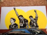 Richard_Bell_and_Emory_Douglas,_‘White_Hero_for_Black_Australia’_mural,_Burnett_Lane,_Brisbane