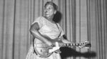 Sister Rosetta Tharpe onstage with her guitar in 1957.